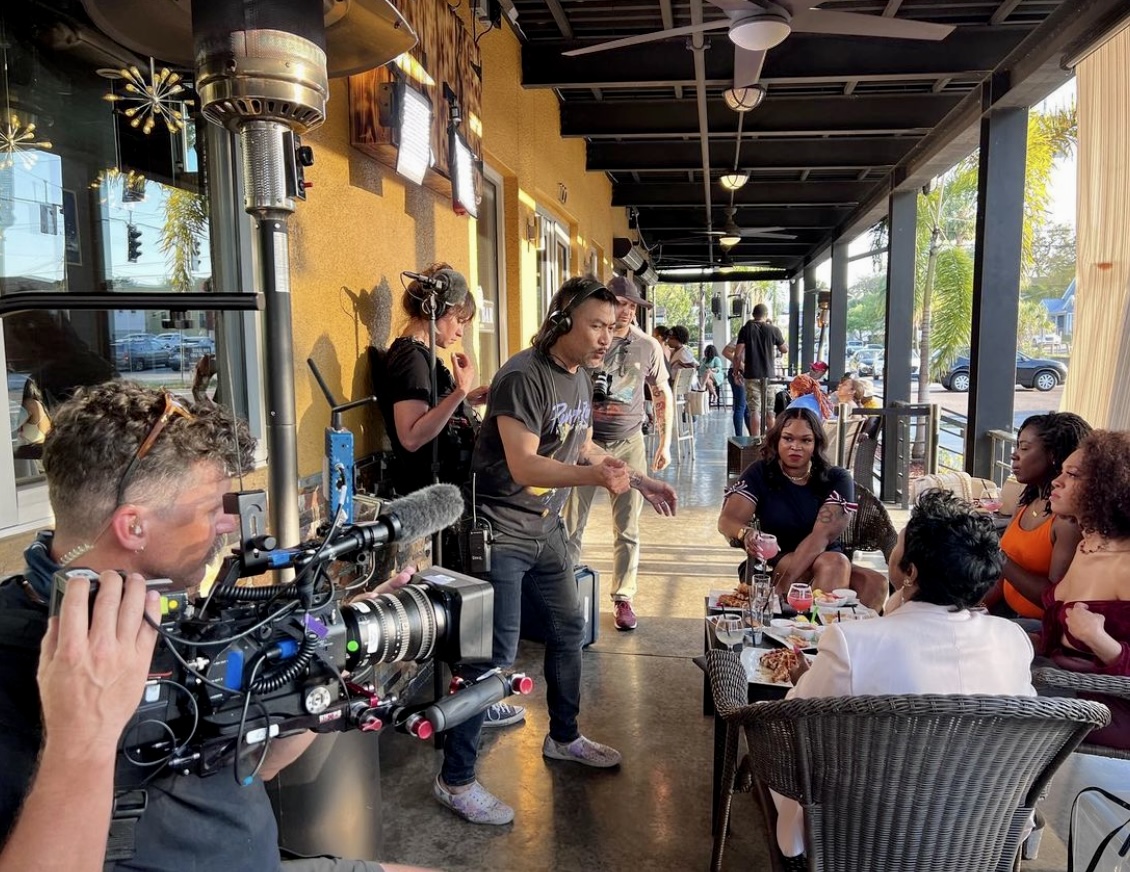 Production crew filming at a restaurant